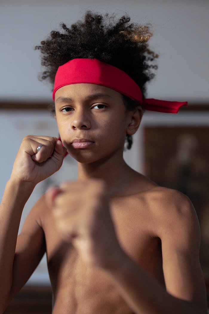 Services Confident young martial artist poses indoors, ready for combat.